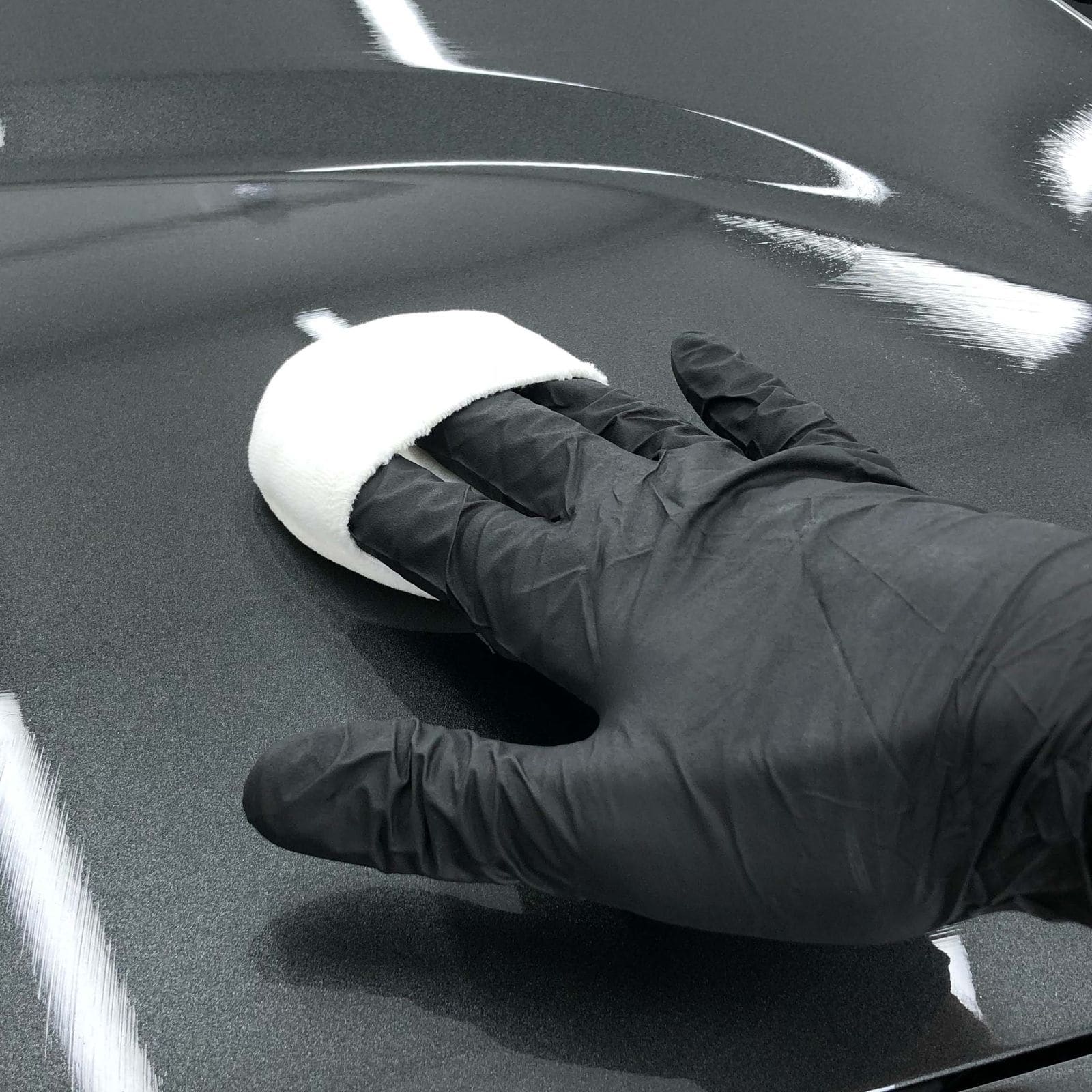 Gyeon Infinite ceramic coating being applied to a car's bonnet