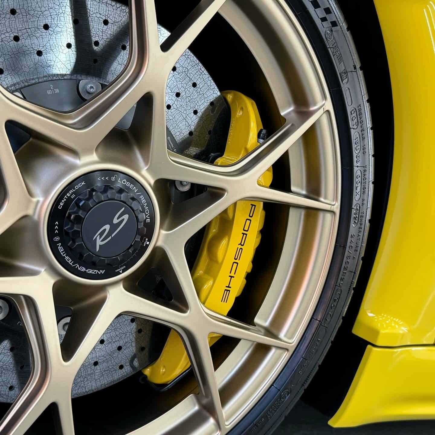 Close up of a Porsche 718 Spyder RS wheel with ceramic coating applied to the wheel and calipers