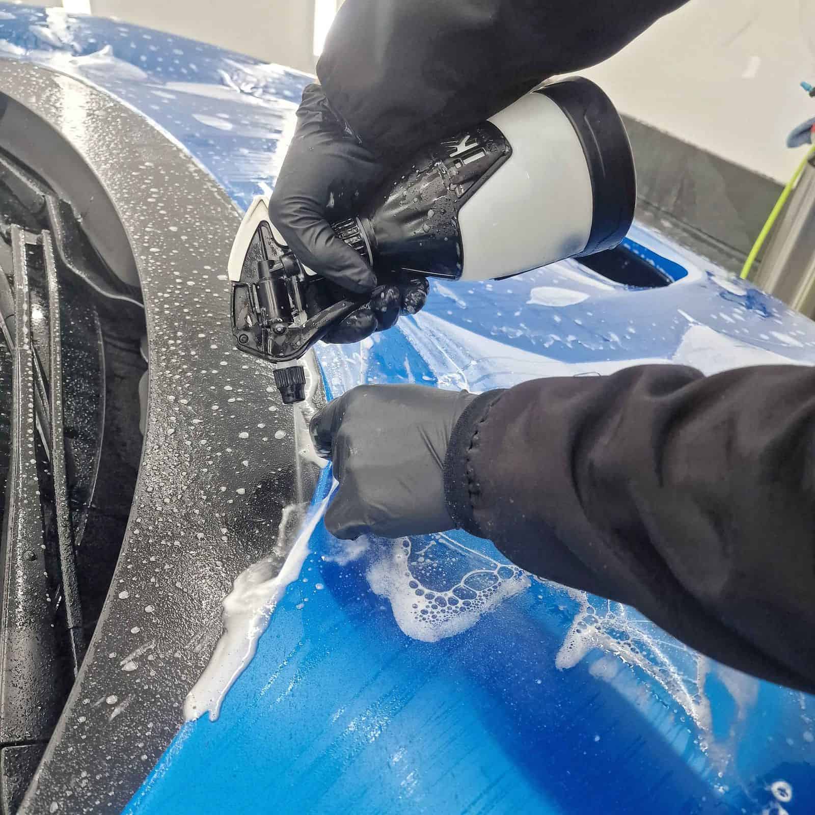A blue Ferrari F8 getting Xpel Stealth PPF installed to the bonnet